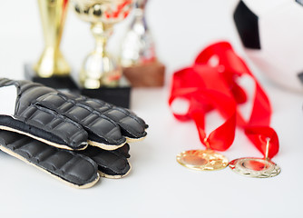 Image showing close up of football, gloves, cups and medals