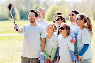 Image showing group of volunteers taking smartphone selfie