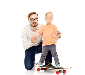 Image showing happy father and little son on skateboard