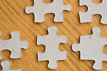 Image showing close up of puzzle pieces on wooden surface