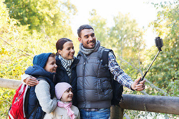 Image showing family with backpacks taking selfie and hiking