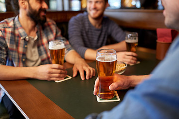 Image showing happy male friends drinking beer at bar or pub