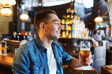 Image showing happy man drinking beer at bar or pub