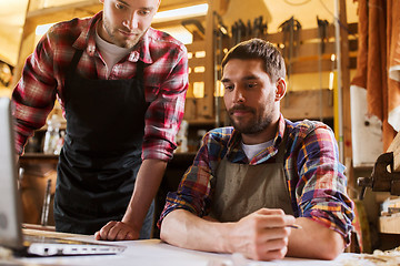 Image showing carpenters with laptop and blueprint at workshop