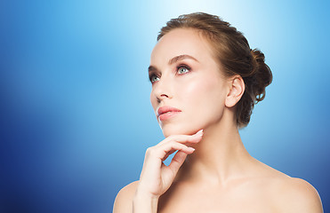 Image showing beautiful young woman touching her face