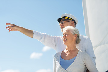 Image showing happy senior couple on sail boat or yacht in sea