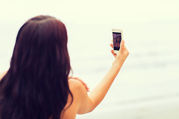 Image showing young woman taking selfie with smartphone