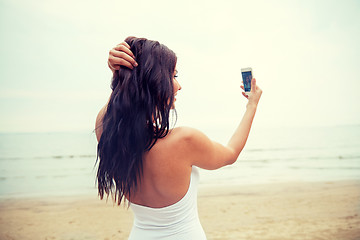 Image showing young woman taking selfie with smartphone