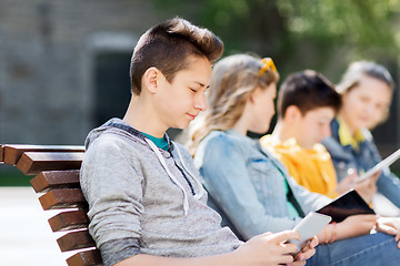 Image showing happy teenage boy with tablet pc computer outdoors