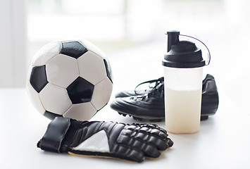 Image showing close up of football boots, gloves and bottle