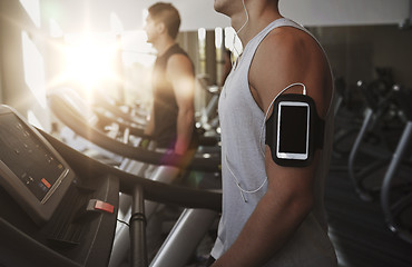 Image showing close up of man with smartphone in gym