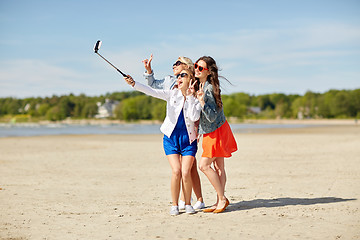 Image showing group of smiling women taking selfie on beach