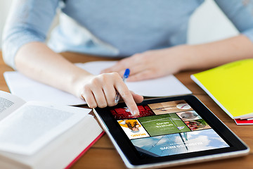 Image showing close up of woman with internet news on tablet pc