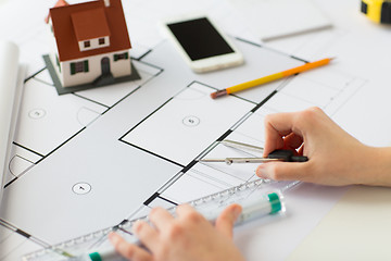 Image showing close up of hands with compass measuring blueprint