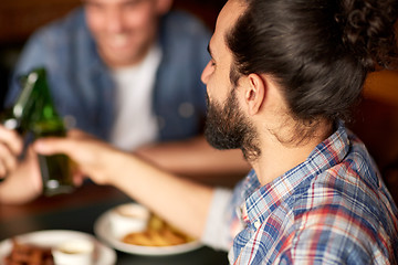 Image showing happy male friends drinking beer at bar or pub