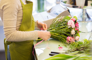 Image showing close up of woman making bunch at flower shop