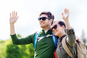 Image showing happy couple with backpacks hiking outdoors