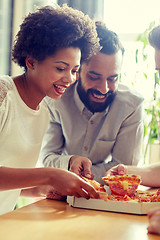 Image showing happy business team eating pizza in office