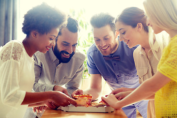 Image showing happy business team eating pizza in office