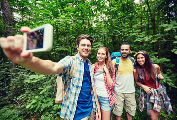 Image showing friends with backpack taking selfie by smartphone