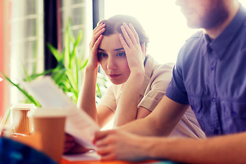 Image showing creative team with reading paper in office