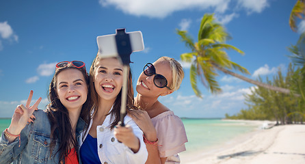 Image showing group of smiling women taking selfie on beach