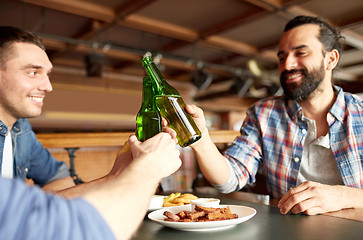 Image showing happy male friends drinking beer at bar or pub