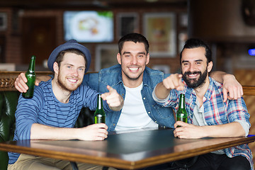 Image showing happy male friends drinking beer at bar or pub