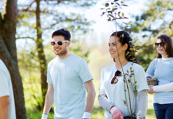 Image showing group of volunteers with trees and rake in park