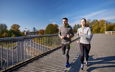 Image showing happy couple running outdoors