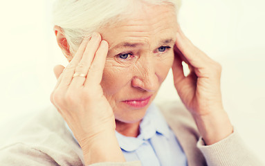 Image showing face of senior woman suffering from headache