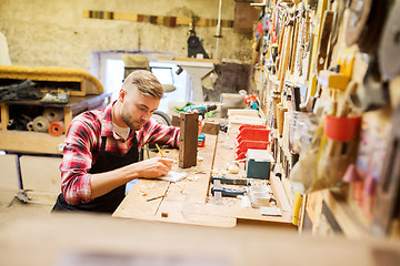 Image showing carpenter working with wood plank at workshop