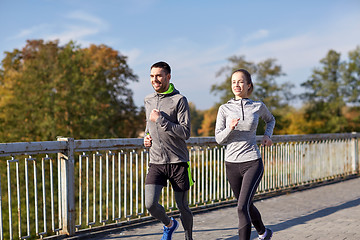 Image showing happy couple running outdoors