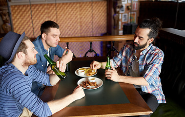 Image showing happy male friends drinking beer at bar or pub