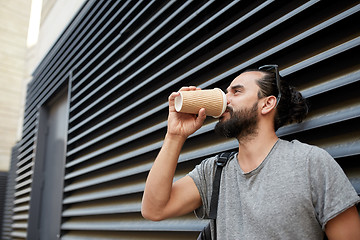 Image showing man drinking coffee from paper cup on street