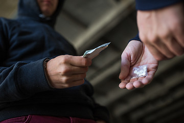 Image showing close up of addict buying dose from drug dealer