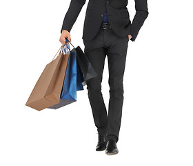 Image showing close up of man in suit with shopping bags