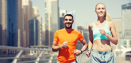 Image showing couple running over dubai city street background