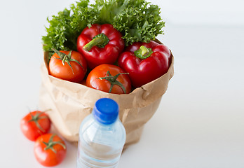 Image showing basket of fresh vegetables and water at kitchen