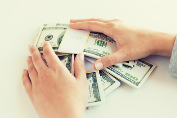 Image showing close up of woman hands counting us dollar money