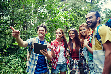 Image showing happy friends with backpacks and tablet pc hiking