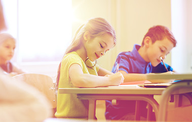 Image showing group of school kids writing test in classroom