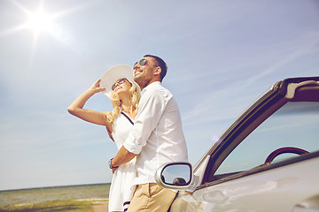 Image showing happy couple hugging near cabriolet car at sea