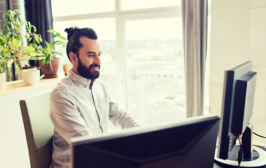 Image showing happy creative male office worker with computer