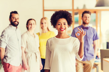 Image showing happy woman showing ok over creative office team