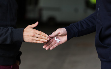 Image showing close up of addict buying dose from drug dealer