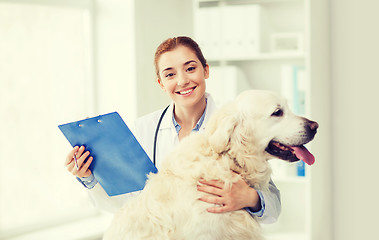 Image showing happy doctor with retriever dog at vet clinic