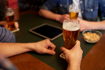 Image showing close up of men drinking beer at bar or pub