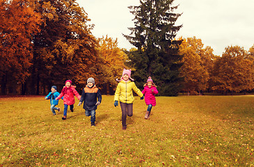 Image showing group of happy little kids running outdoors