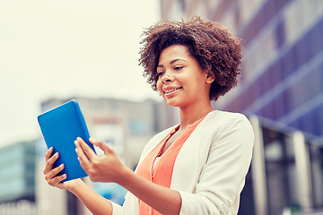 Image showing happy african businesswoman with tablet pc in city